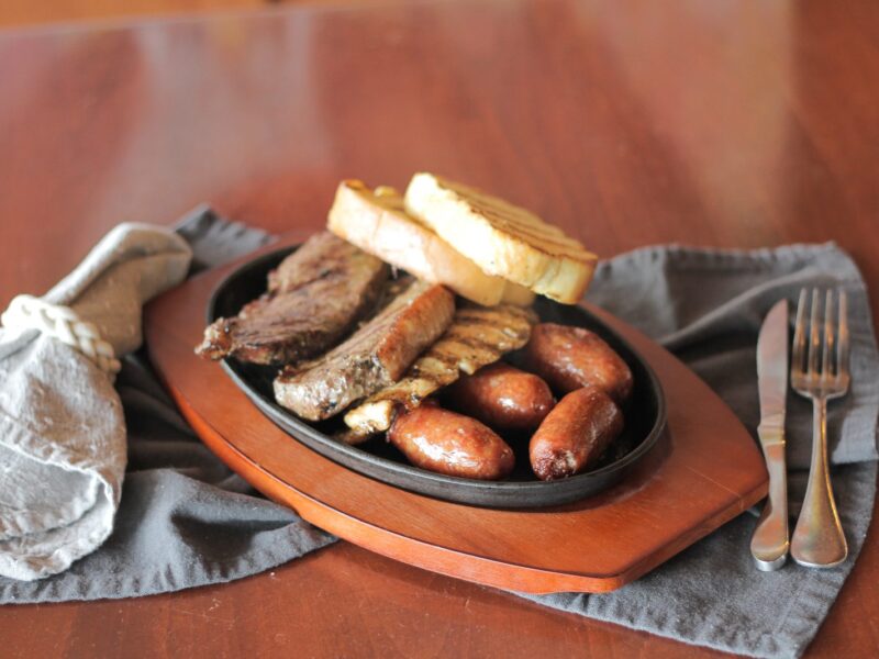 Brazilian churrasco cooking over open flame