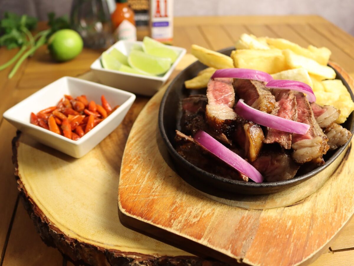 Sliced picanha strips served with fries