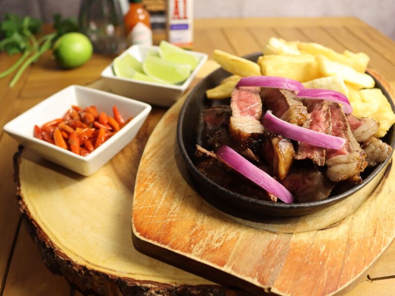 Sliced picanha strips served with fries